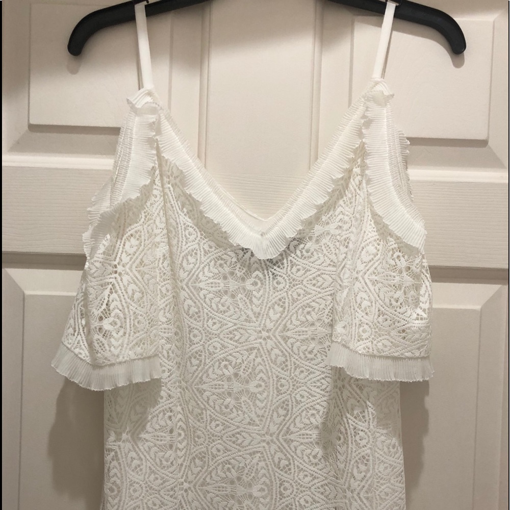 Ivory lace cold-shoulder top with ruffled accents